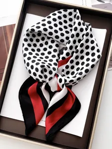 Close-up of silk-feel square scarf with classic polka dots and striped borders