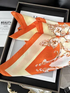 Detail of vintage Baroque pattern on orange silk scarf with polished satin texture
