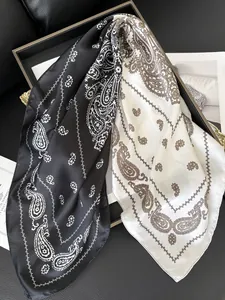 Detail of silk-like paisley square scarf in black and white dual color combinations