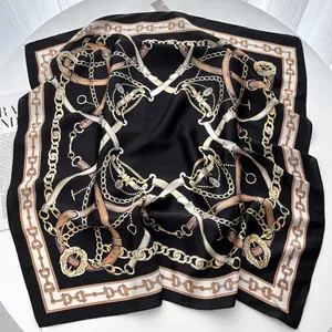 Detail of elegant 70cm silk-like scarf featuring vintage gold chain and buckle patterns