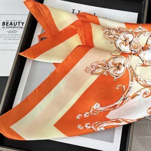 Elegant silk scarf featuring orange and beige baroque patterns with striped accents