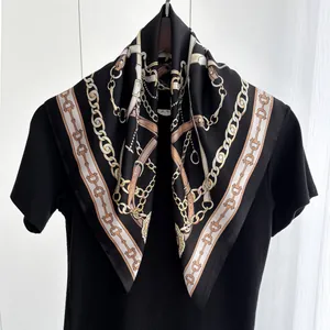 Detail of elegant black and gold chain pattern on silk-like square scarf for women