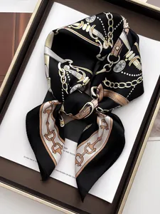 Detail of silk-like square scarf featuring vintage equestrian chain and buckle patterns