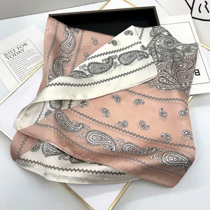 Detailed texture of two-tone paisley silk scarf in dusty pink and cream white colors