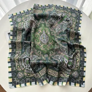 Detail of green paisley silk square scarf with checkered border and vintage patterns