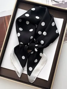 Close-up of silk-textured black square scarf with white polka dots and border