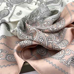 Detailed close-up of paisley pattern satin scarf featuring smooth silk-like texture and finish
