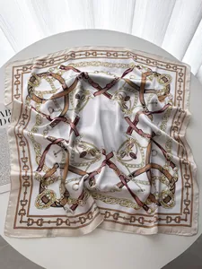 Detail of silk square scarf featuring classic European chain and belt print design