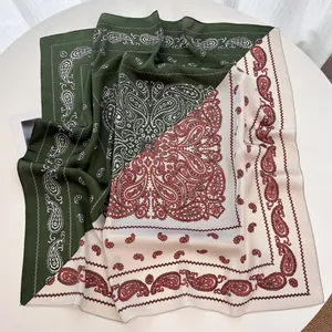 Close-up of two-tone paisley silk scarf with olive green and beige vintage patterns