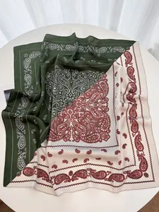 Detailed view of paisley silk scarf with dark green and cream diagonal stitching