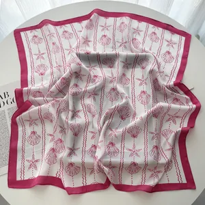 Detail of seashell and starfish print on silk-like square scarf with pink borders