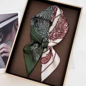 Detail of paisley silk scarf with contrast stitching in a premium gift box tray