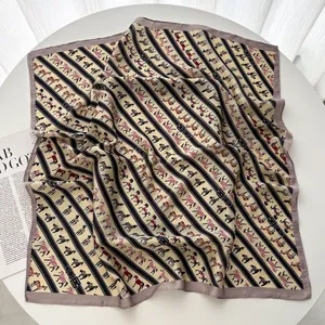 Detailed view of square silk scarf with vintage equestrian horse motifs and yellow stripes
