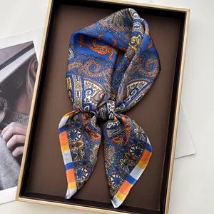 Detail of paisley silk scarf with vibrant blue and orange patterns in a gift box