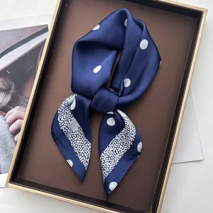 Navy blue silk scarf with white polka dots and leopard print in elegant knot style