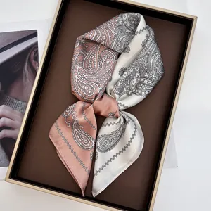 Coral and cream paisley silk scarf in a premium gift box with high-end texture