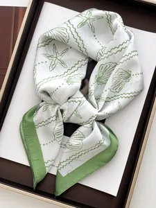 Detail of high-density silk scarf with elegant olive green seashell and starfish pattern