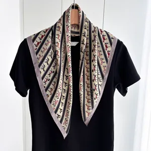 Ethnic square silk scarf with horse print on beige background worn over black tee