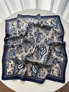 Detail of navy blue paisley silk scarf with elegant drape and smooth satin texture