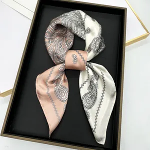 Elegant champagne pink and cream paisley silk scarf tied in a bow in a premium gift box