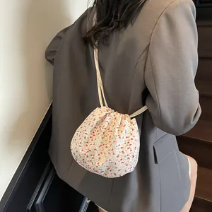 Floral drawstring shoulder bag for women featuring a vintage red flower pattern and strap