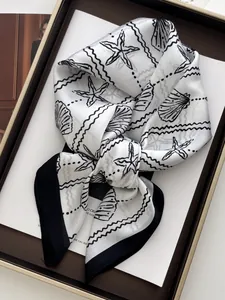Silk-like square scarf with seashell print and black borders in a premium gift box