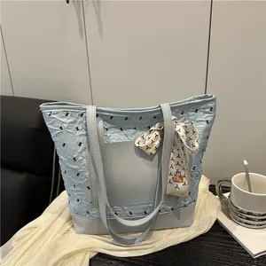 Light blue cloud tote bag with ruched fabric and decorative silk scarf on handle