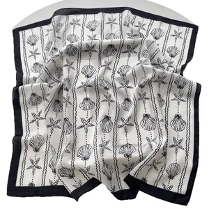 Elegant black and white silk scarf with starfish and seashell patterns on sheer fabric