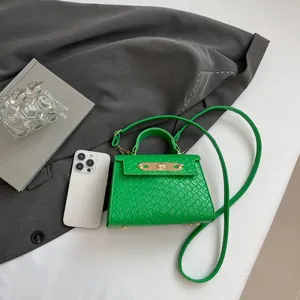 Green trapezoid mini handbag with woven texture and gold hardware for women