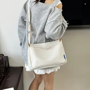 Minimalist white canvas messenger bag with large capacity for daily casual use
