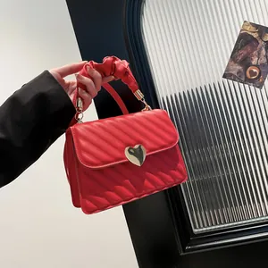Red quilted faux leather handbag with golden heart lock and chic scrunchie handle