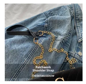 Detailed view of the black quilted crossbody bag with gold chain and leather shoulder strap