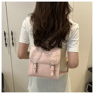 Detailed view of pink sweet lace backpack with bow stitching and heart charm accessory