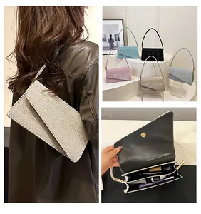 Detail view of glitter crossbody bag with asymmetric flap and multi-compartment interior
