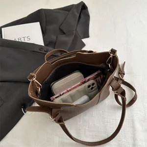 Vintage brown lychee grain leather bucket bag with top handle and spacious interior
