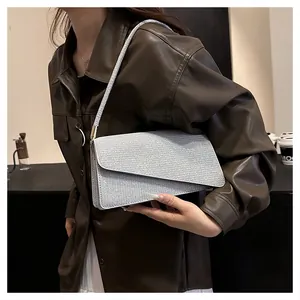 Detail view of the silver sequin shoulder bag with elegant flap design and slim strap