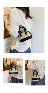 Chic woven shell bag with black leather trim shown on model for a casual summer outfit