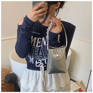Chic silver metallic mini bag featuring metal sphere clasp and chain strap detail