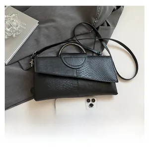 Detailed comparison of the snakeskin patchwork bag size with a smartphone