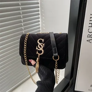Chic black velvet quilted chain crossbody bag with golden letter and tassel decor