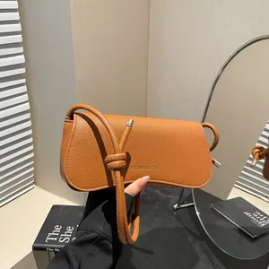 Fashion caramel leather underarm bag with knotted shoulder strap and gold logo