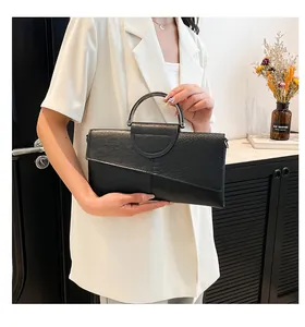 Close-up of black envelope clutch with snakeskin texture and semi-circular metal handle