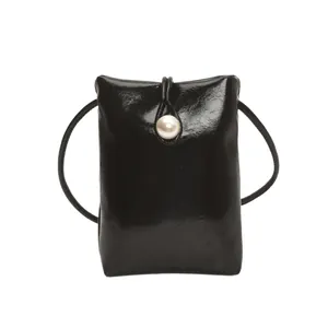 Glossy black mini crossbody phone bag with elegant pearl clasp and thin strap