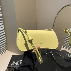 Chic lemon yellow lychee leather shoulder bag with FASHION & BAGS text and knotted strap