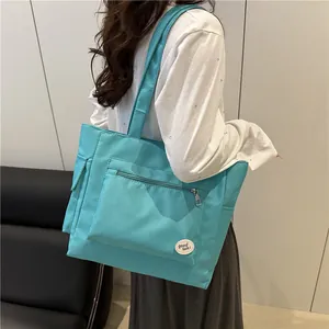 Minimalist mint green nylon tote bag with large capacity and shoulder straps for daily use