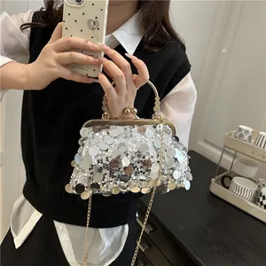 Silver sequin evening clutch bag with gold handle and metal frame clasp detail