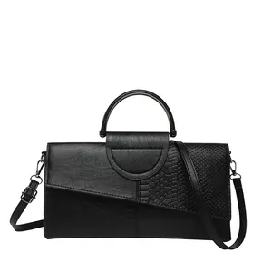 Black patchwork snakeskin envelope clutch with curved handle and detachable shoulder strap