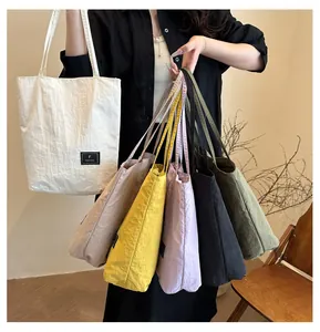 Detailed view of lightweight nylon tote bags in six different vibrant colors