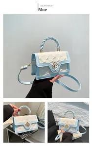 Detail of light blue crossbody bag featuring a golden flower lock and woven handle