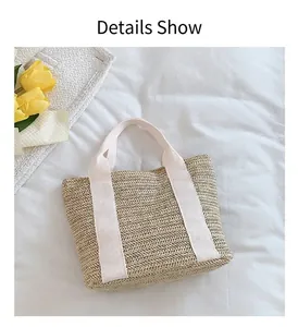 Detail of woven straw tote bag with cream canvas handles and texture craftsmanship